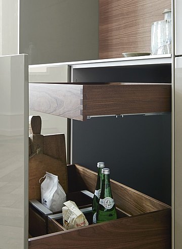 Different height pull-outs in a single drawer create functional yet aesthetic storage space